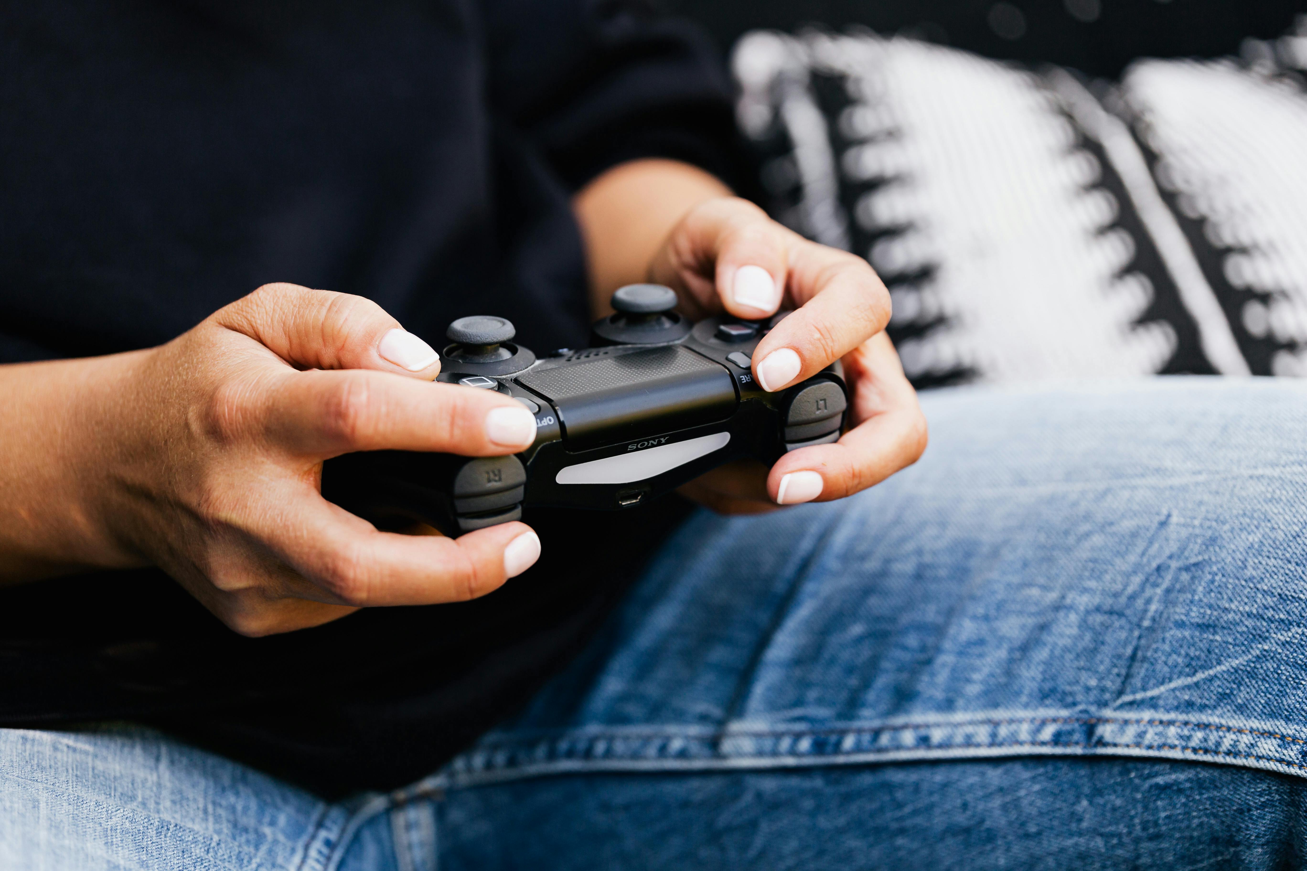 person holding black game controller