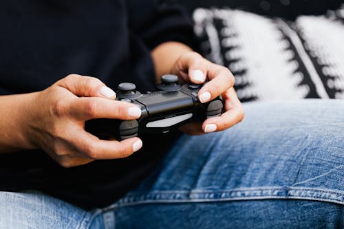 Person Holding Black Game Controller