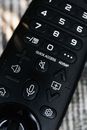 Black Remote Control on Brown Textile