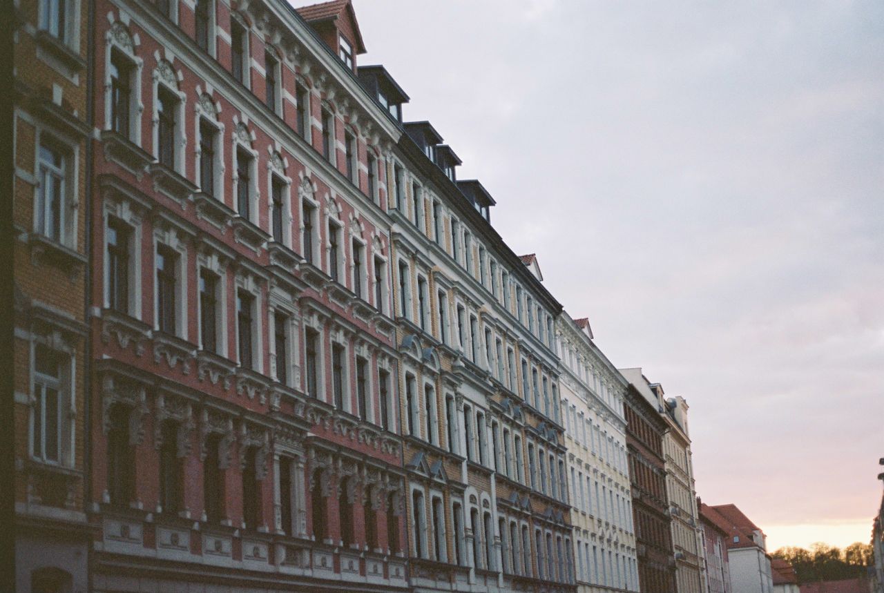 perspective view facade of aged multicolored building with ornamental