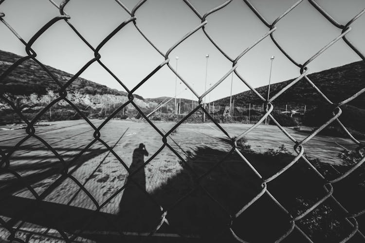 Chain Link Fence Surrounding Sports Ground In Countryside