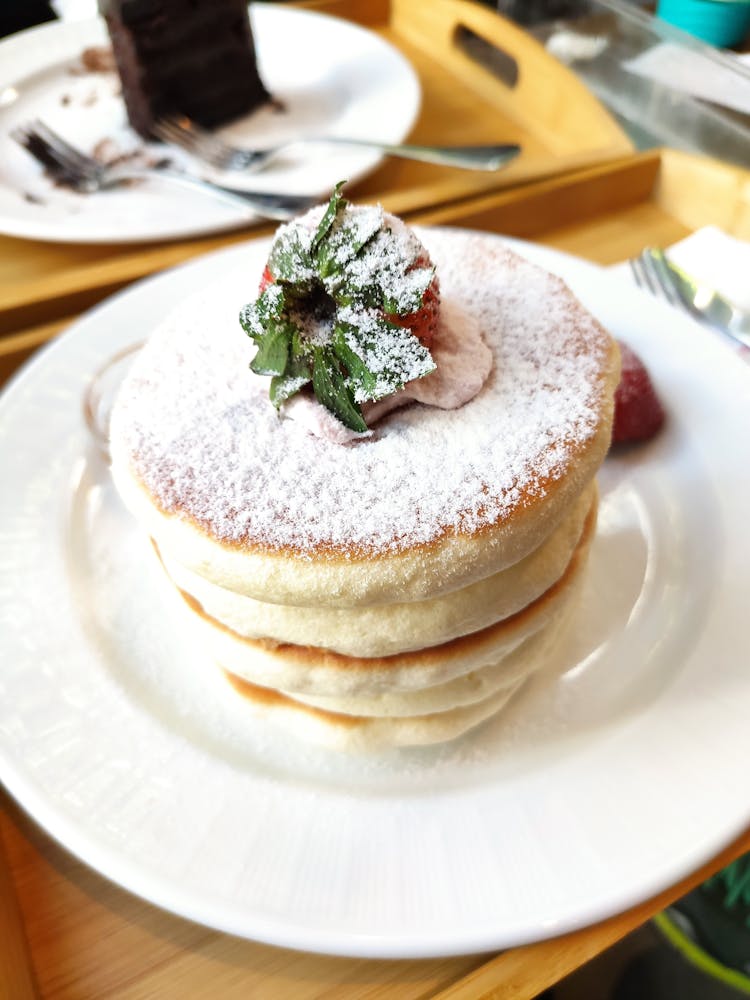 Stack Of Fluffy Pancakes Topped With Straw