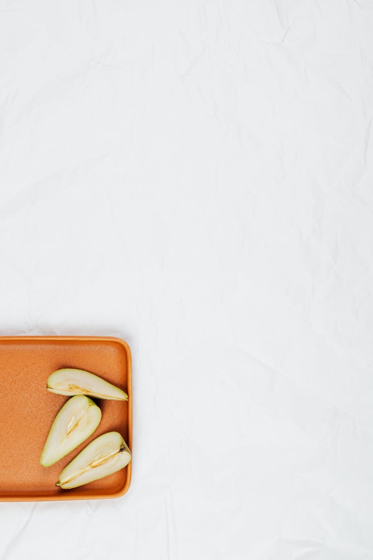 Cut Pear Fruit In Brown Tray