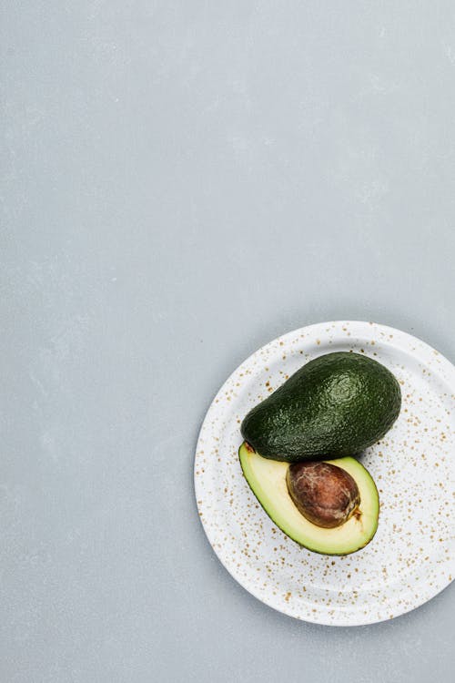 Free Sliced Green Avocado on a Plate Stock Photo