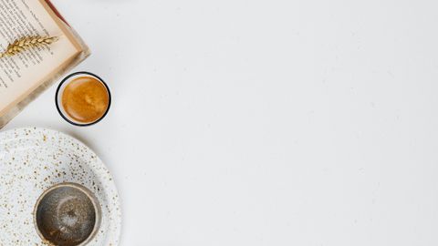 Flat lay of assorted nuts and seeds with empty space on a white background.