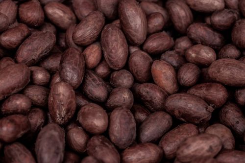 Free A detailed close-up of raw cocoa beans from Nigeria, showcasing their natural texture and rich color. Stock Photo