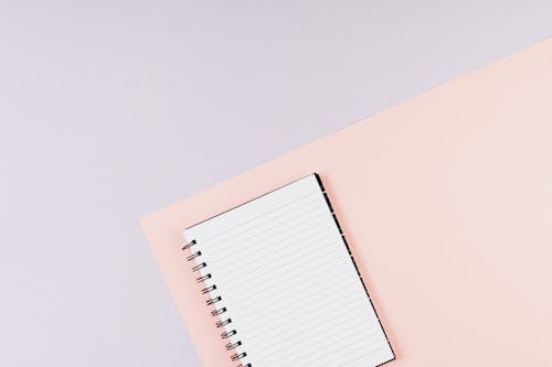 Spiral Notebook on Pink Surface