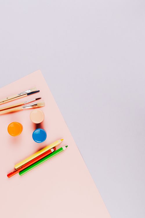 Free Colorful art supplies on a pink surface with ample copy space, ideal for creativity themes. Stock Photo