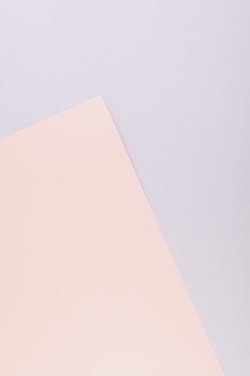 Free Abstract minimalistic flat lay of light pink and white paper with a soft pastel tone. Stock Photo