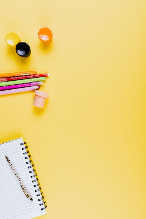 Free Top view of various school supplies on a yellow background. Stock Photo
