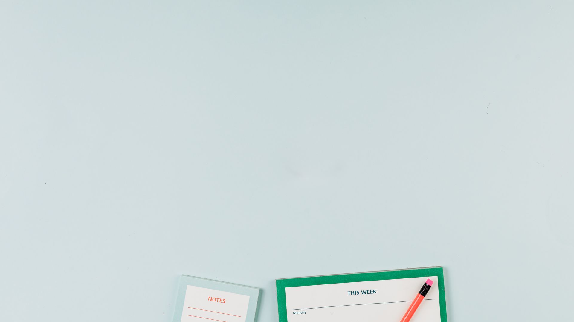 Letter Pads: Your Essential Stationery Companion 5 Simple flat lay of a notepad and red pencil on a light blue background, ideal for office themes — letter pads