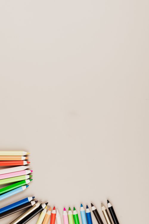 Free Top view of multiple colored pencils arranged on a beige background with ample copy space. Stock Photo