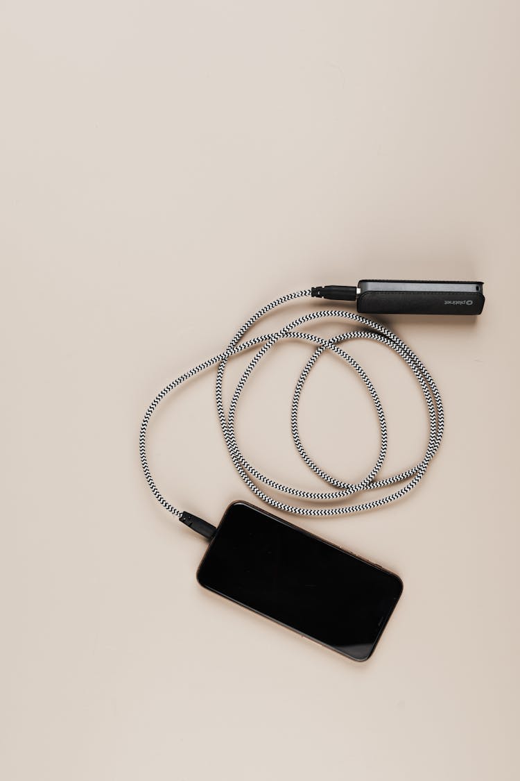 Overhead Shot Of A Cellphone Charging From A Power Bank