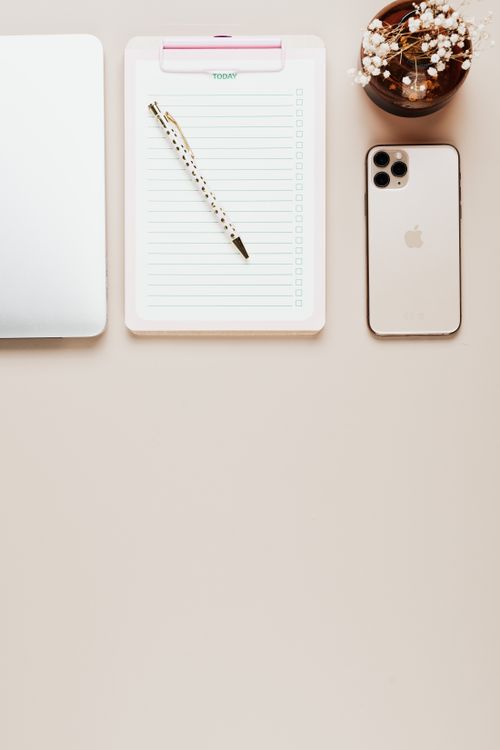 Free Elegant minimalist workspace setup with a notepad, pen, and smartphone on a clean surface. Stock Photo