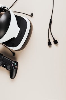 Modern VR headset and game controller on beige background with copyspace, perfect for gaming concepts.