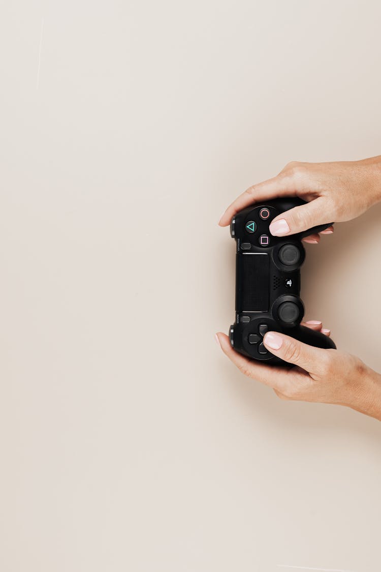 Flat Lay Shot Of A Person Holding A Video Game Controller