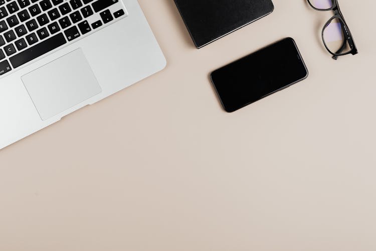 Smartphone And A Laptop Keyboard On A Flat Surface