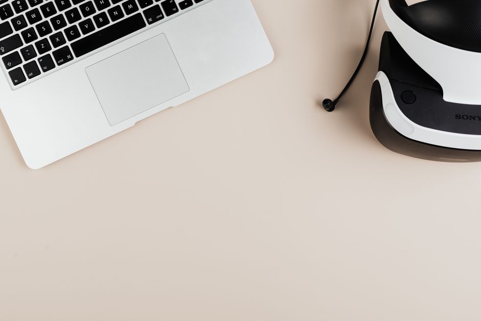 Does LectroFan or Hatch Restore Better Improve Sleep Quality? A flat lay of a laptop and VR headset on a clean surface, showcasing modern technology.