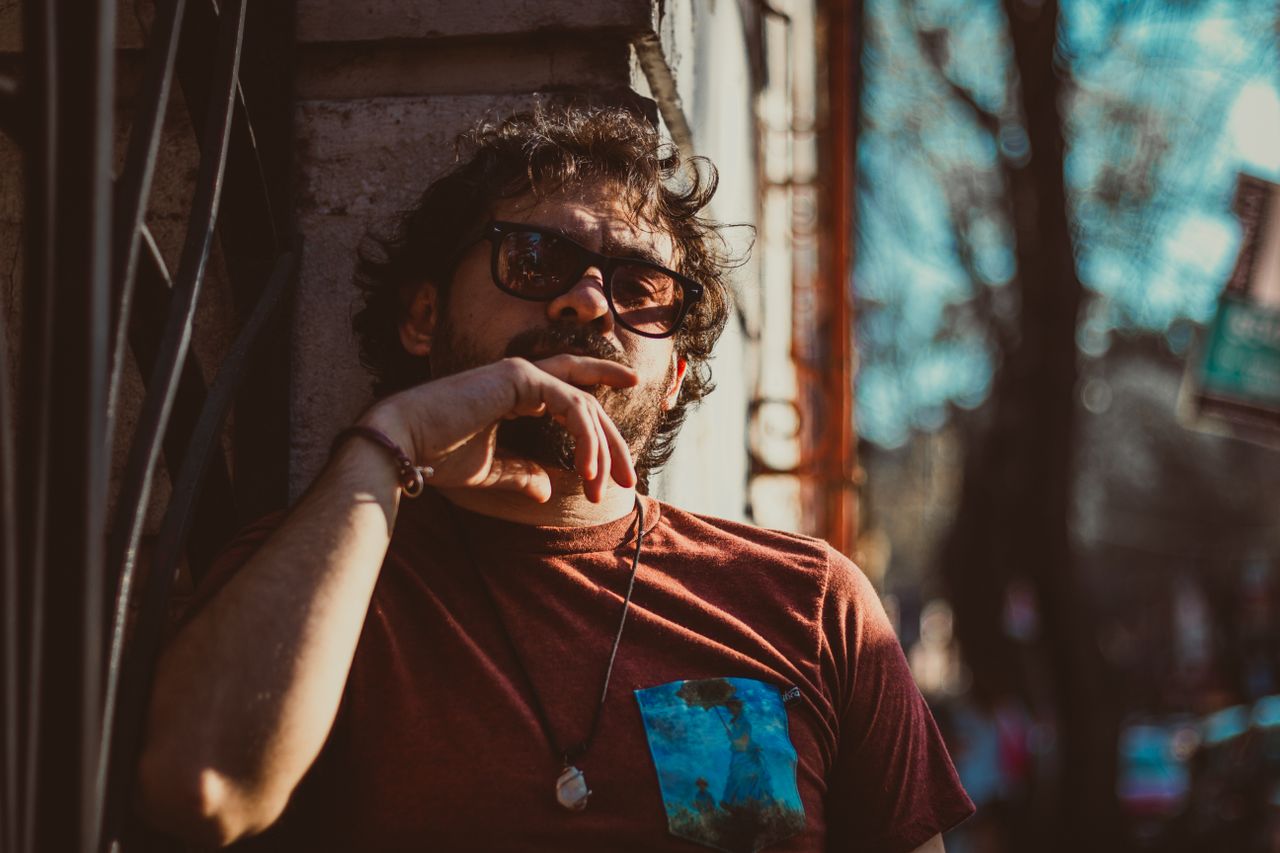 portrait of a bearded man in sunglasses relaxing outdoors in cdmx mexi