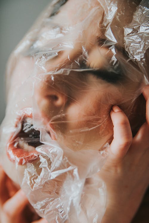 Woman suffocating with plastic bag on head