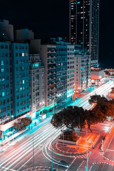 Vibrant night cityscape of Rio de Janeiro showcasing illuminated buildings and dynamic light trails.