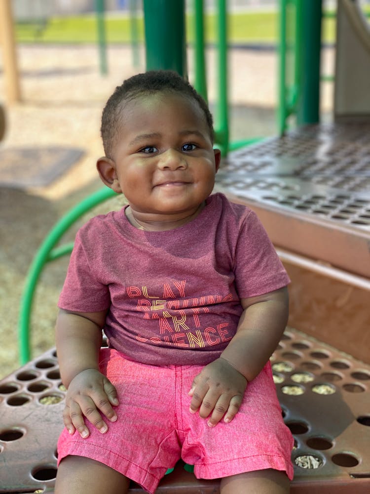 A Toddler Sitting On Stairs Step