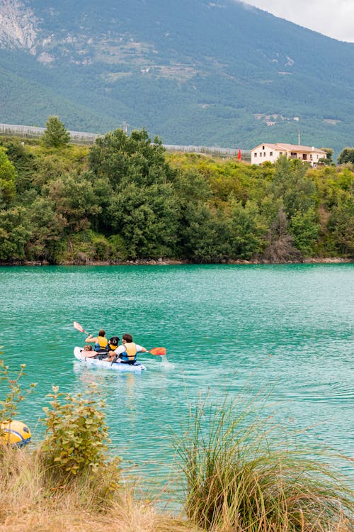 A Couple Paddling a Kayak in the Lake