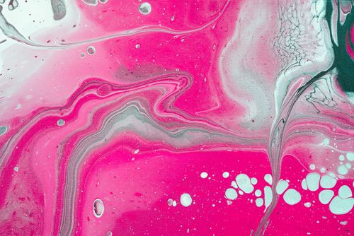 Free Close-up of a vibrant abstract acrylic painting featuring swirling pink and white patterns. Stock Photo