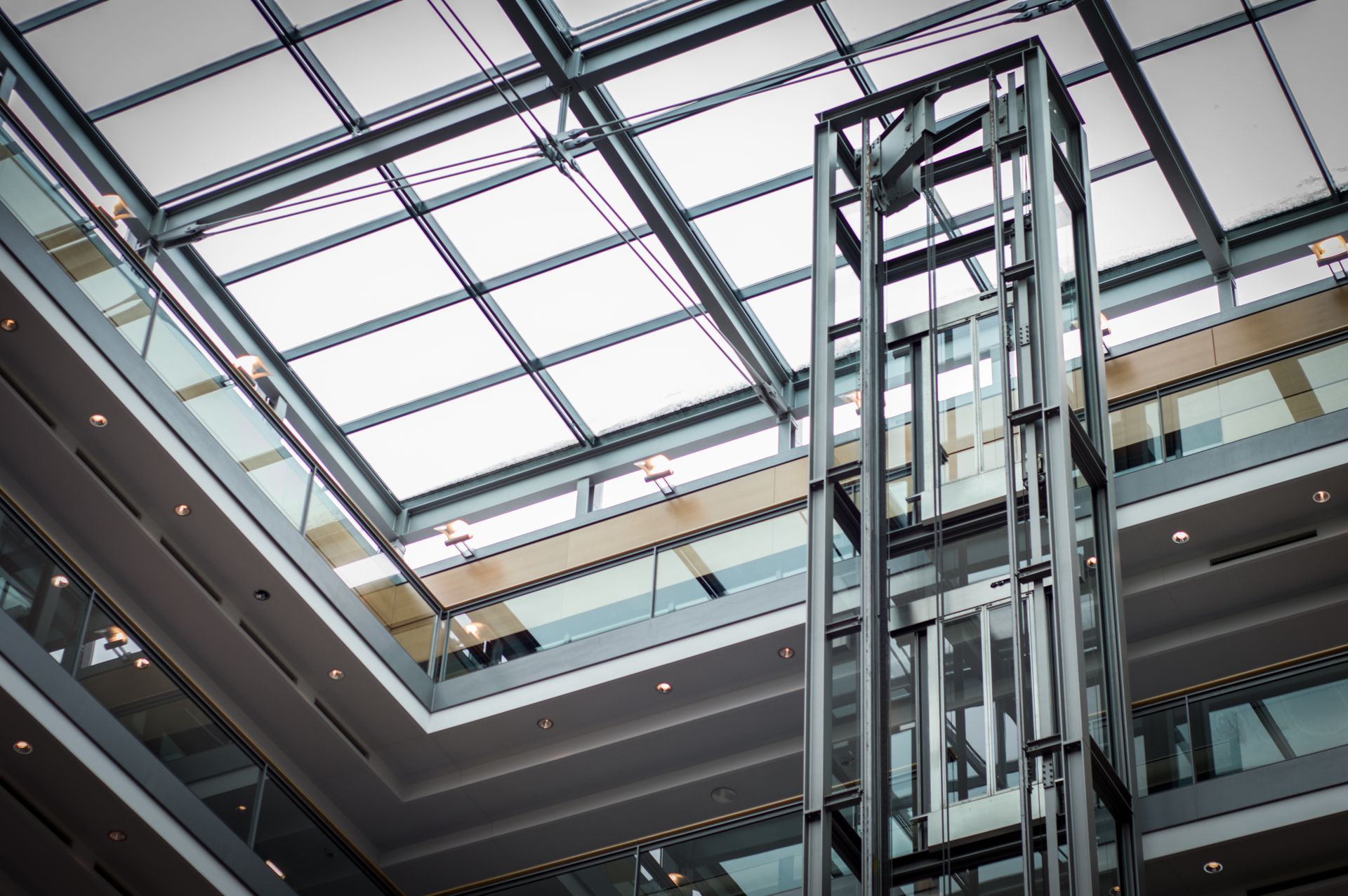 Glass capsule lift in a modern building atrium