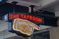 Glowing signboard of pub hanging near entrance
