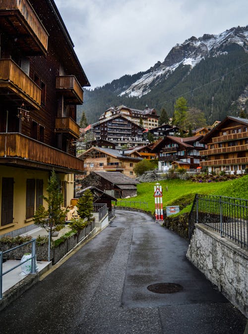 Free Empty street amidst residential cottages in mountainous valley Stock Photo