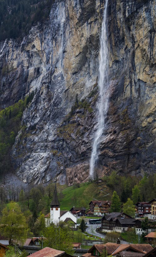 Breathtaking Staubbach Fall waterfall flowing through rocky cliff near village of Lauterbrunnen in Switzerland