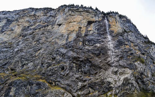 Water cascade streaming through huge rocky ravine