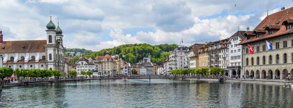 Explore Lucerne's picturesque cityscape featuring historical architecture along the Reuss river.
