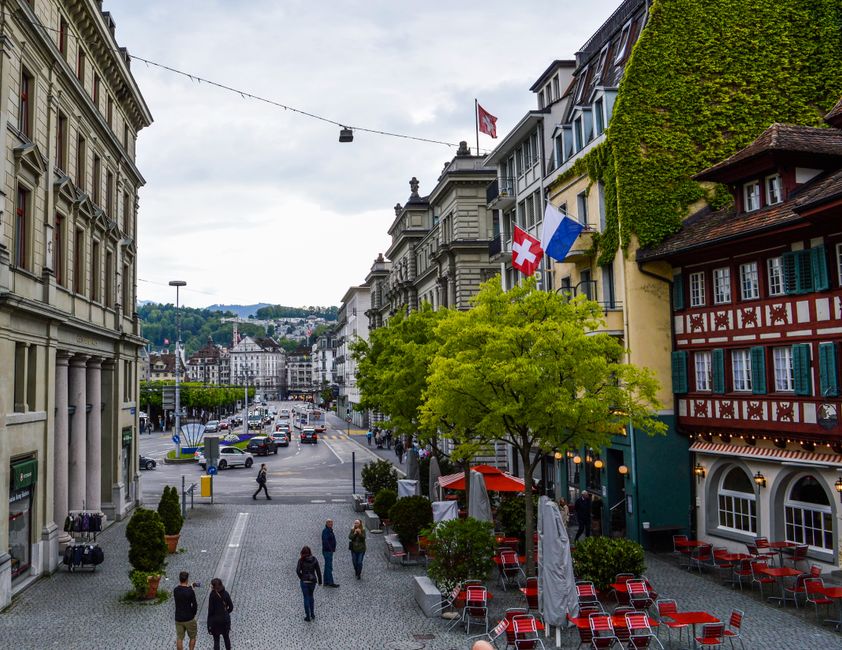 A guided walking tour group exploring the historic Old Town of Lucerne, Switzerland