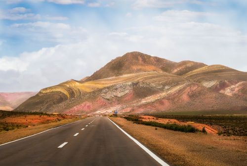 Free A deserted road through vibrant Andean mountains under a bright sky, perfect for travel inspiration. Stock Photo