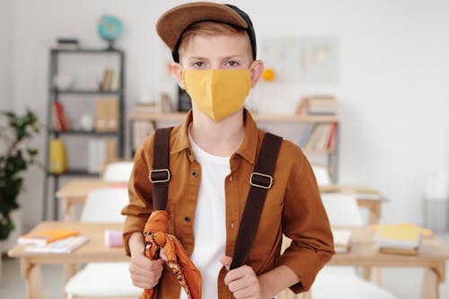 Free Boy Holding His Backpack Wearing Face Mask  Stock Photo