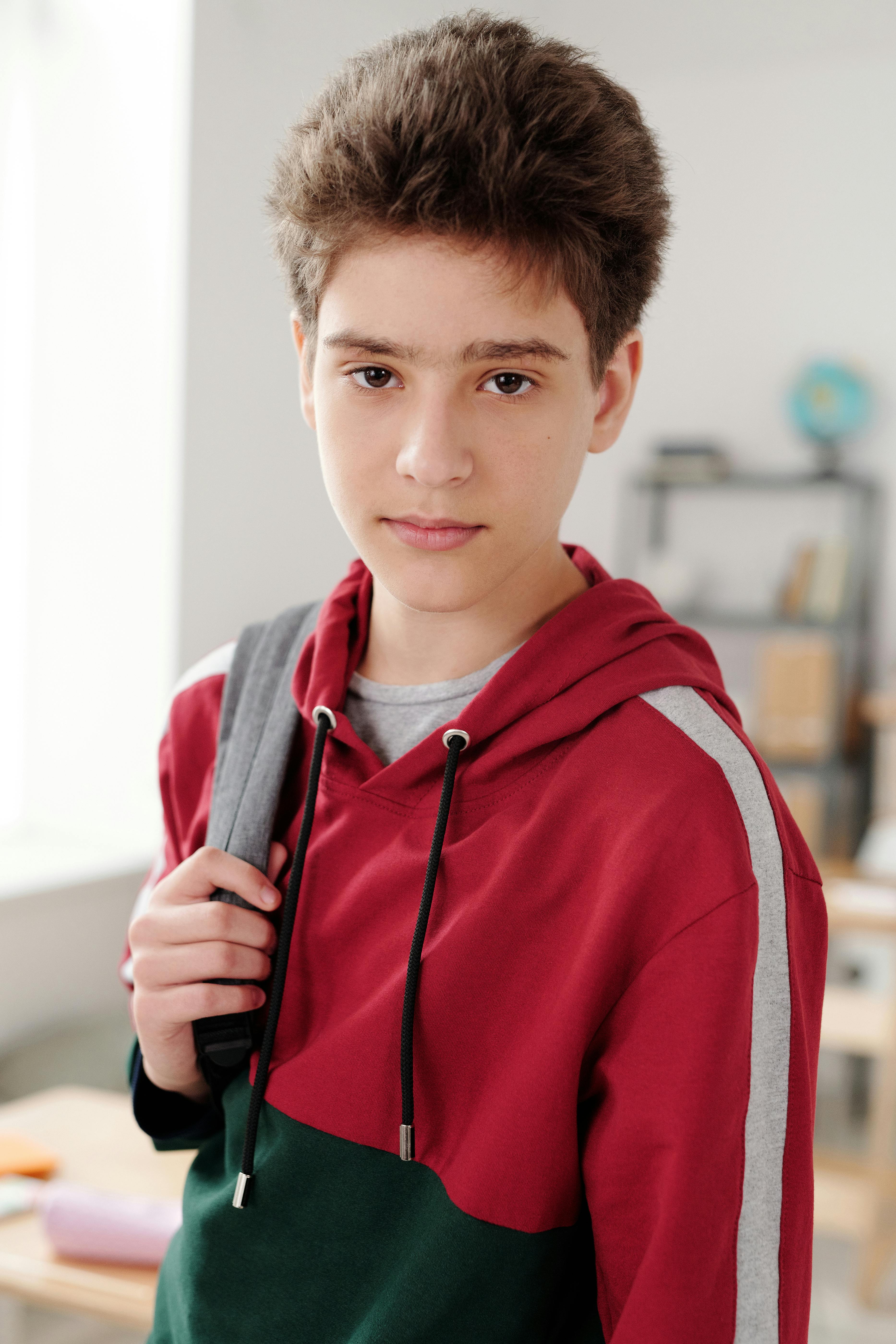 boy in red and gray hoodie