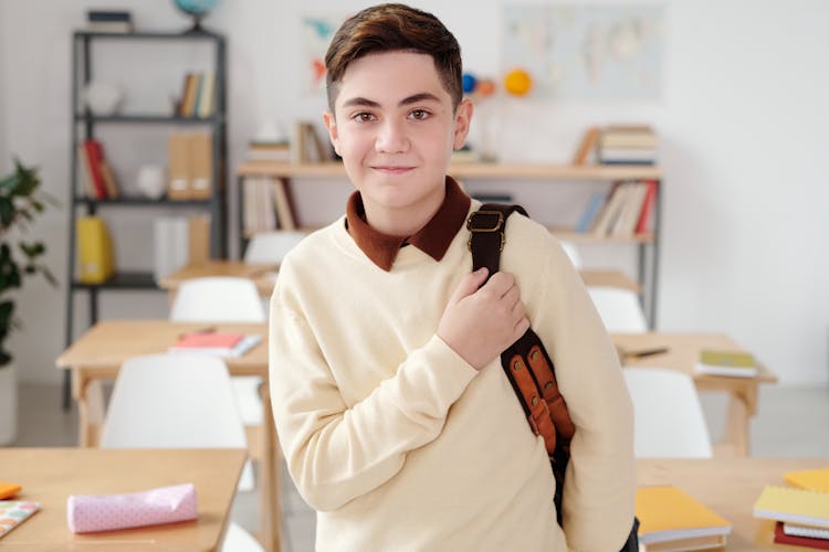 Boy Standing Inside A Classroom