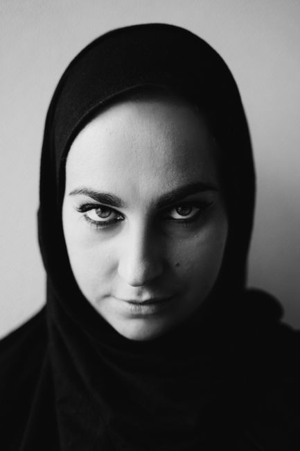 A powerful monochrome close-up of a woman in a hijab, evoking depth and emotion.