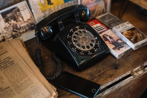 Free Mobile Phone next to a Rotary Phone Stock Photo