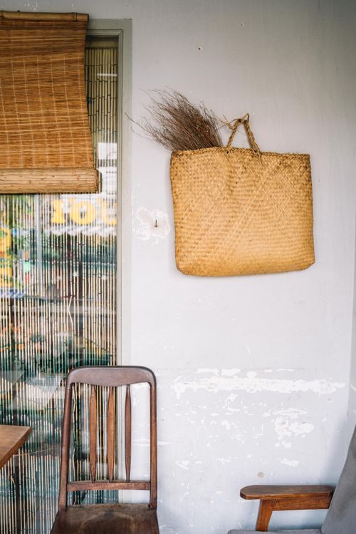 Free Cozy interior with wooden chair, wicker basket and bamboo decor. Stock Photo