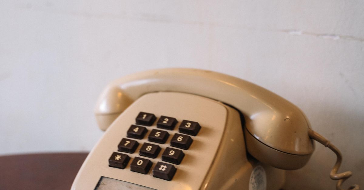 A Beige Corded Telephone on a Table · Free Stock Photo