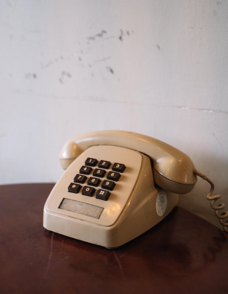 A Beige Corded Telephone On A Table