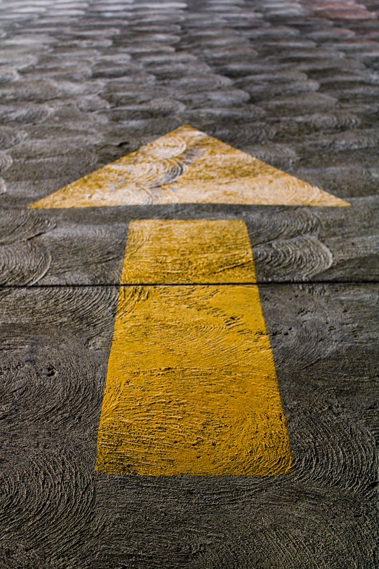 A Yellow Arrow On A Floor