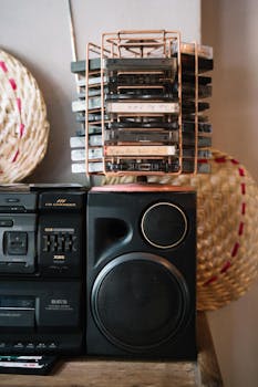 A nostalgic view of a vintage boombox and cassette tapes neatly stacked in a rack.
