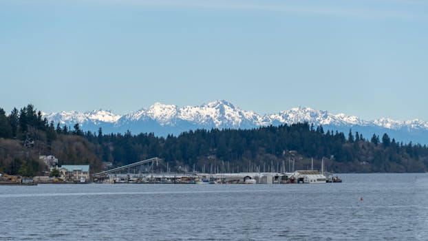 Scenic view of the snow-capped Olympic Mountains and marina over Puget Sound in Washington State.