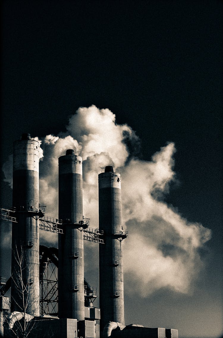 Grayscale Photo Of Factory Chimneys