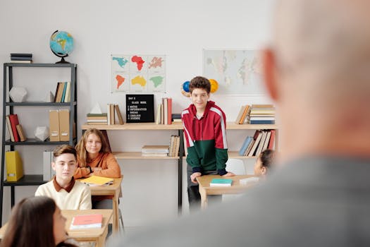 Students attentively listening in a classroom environment, promoting learning and engagement.