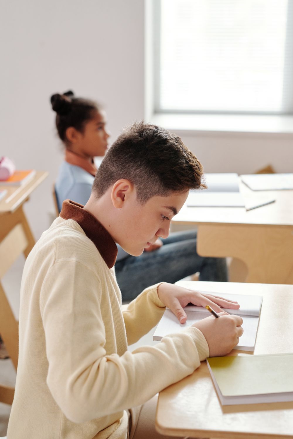 Parent helping child with homework on the floor